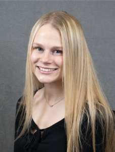 A woman in a black shirt smiling. 